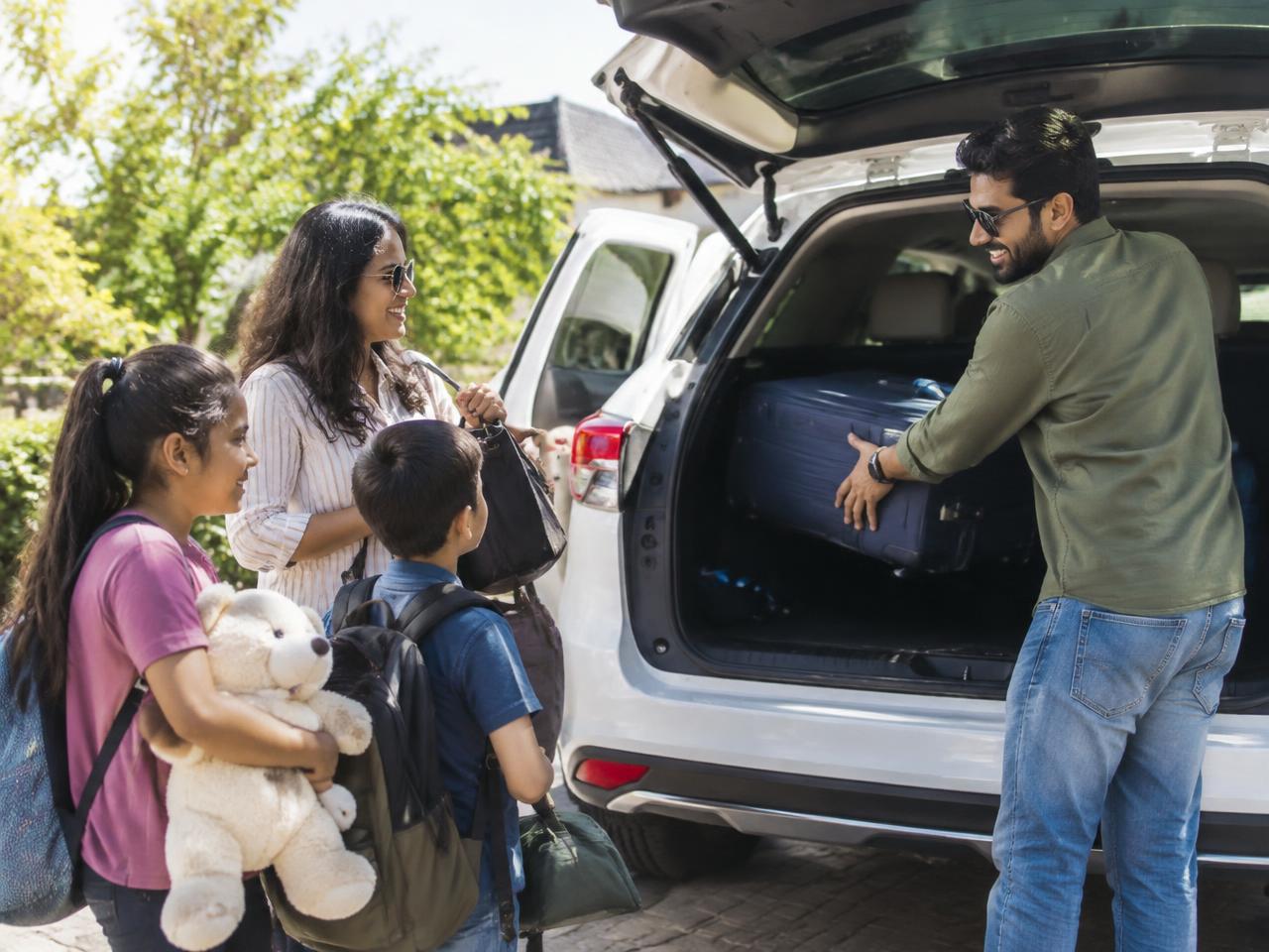 Indian family loading luggage for a road trip